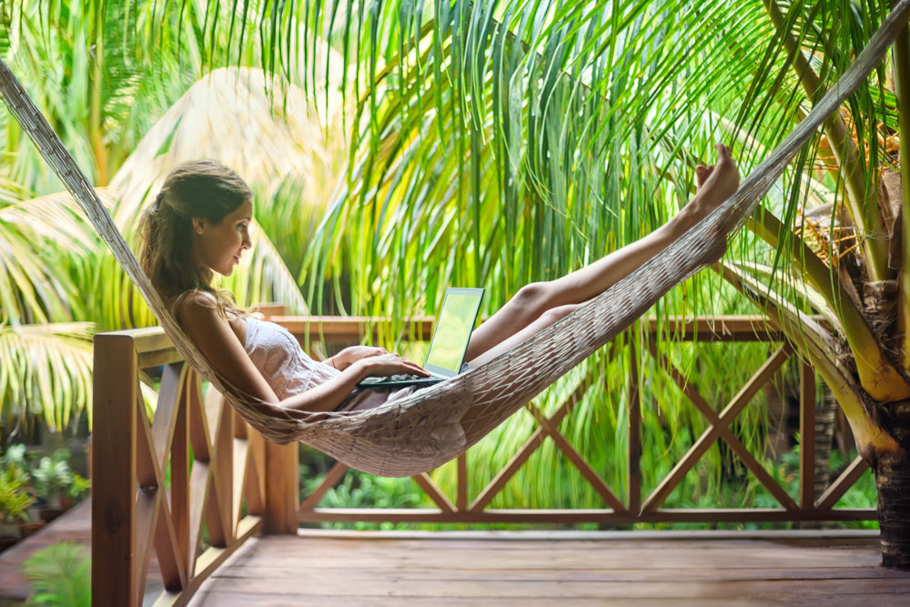 Young-woman-lying-in-a-hammock-with-laptop-520609970_5616x3744—Career